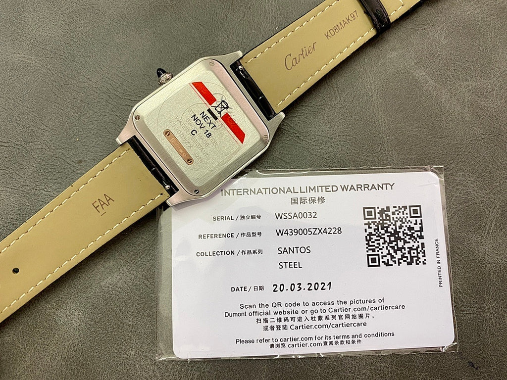 Cartier wristwatch with black and tan leather strap, clasp and warranty label