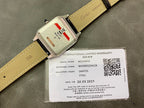 Cartier wristwatch with black and tan leather strap, clasp and warranty label