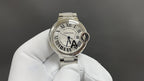 Cartier watch, silver metal bracelet, white dial with Roman numerals and blue hands