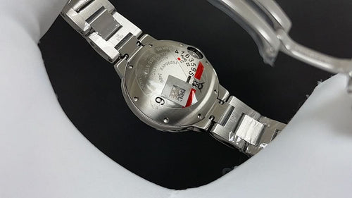 Cartier watch caseback with silver bracelet links and clasp, red detail on back