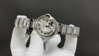 Cartier watch with silver link bracelet and white dial, side crown and bezel visible
