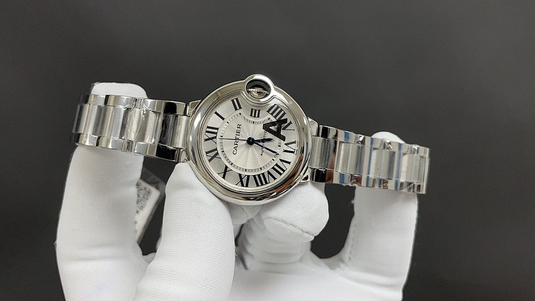 Cartier watch with silver link bracelet and white dial, side crown and bezel visible
