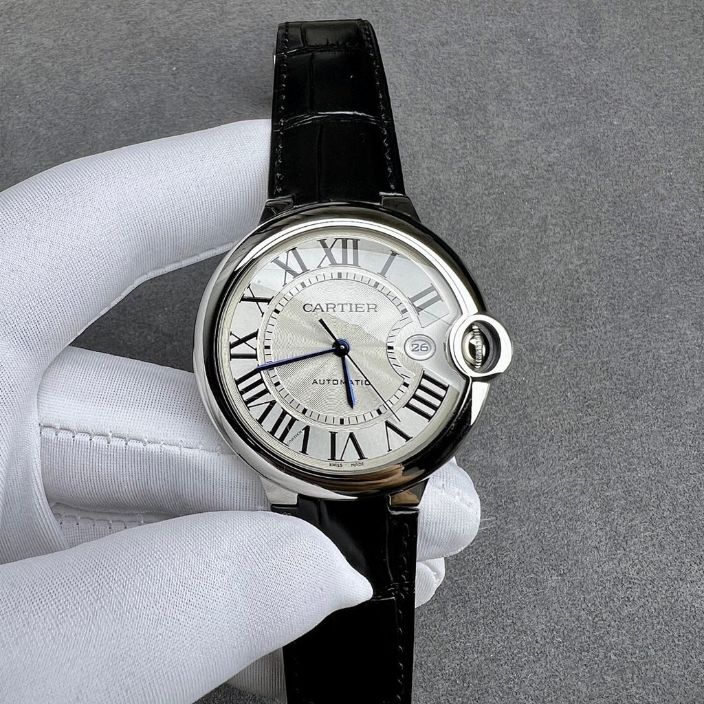 Cartier watch angled view: black leather strap, silver case, Roman numeral white dial.