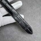 Cartier watch black leather strap with stitched pattern, silver case edge visible.