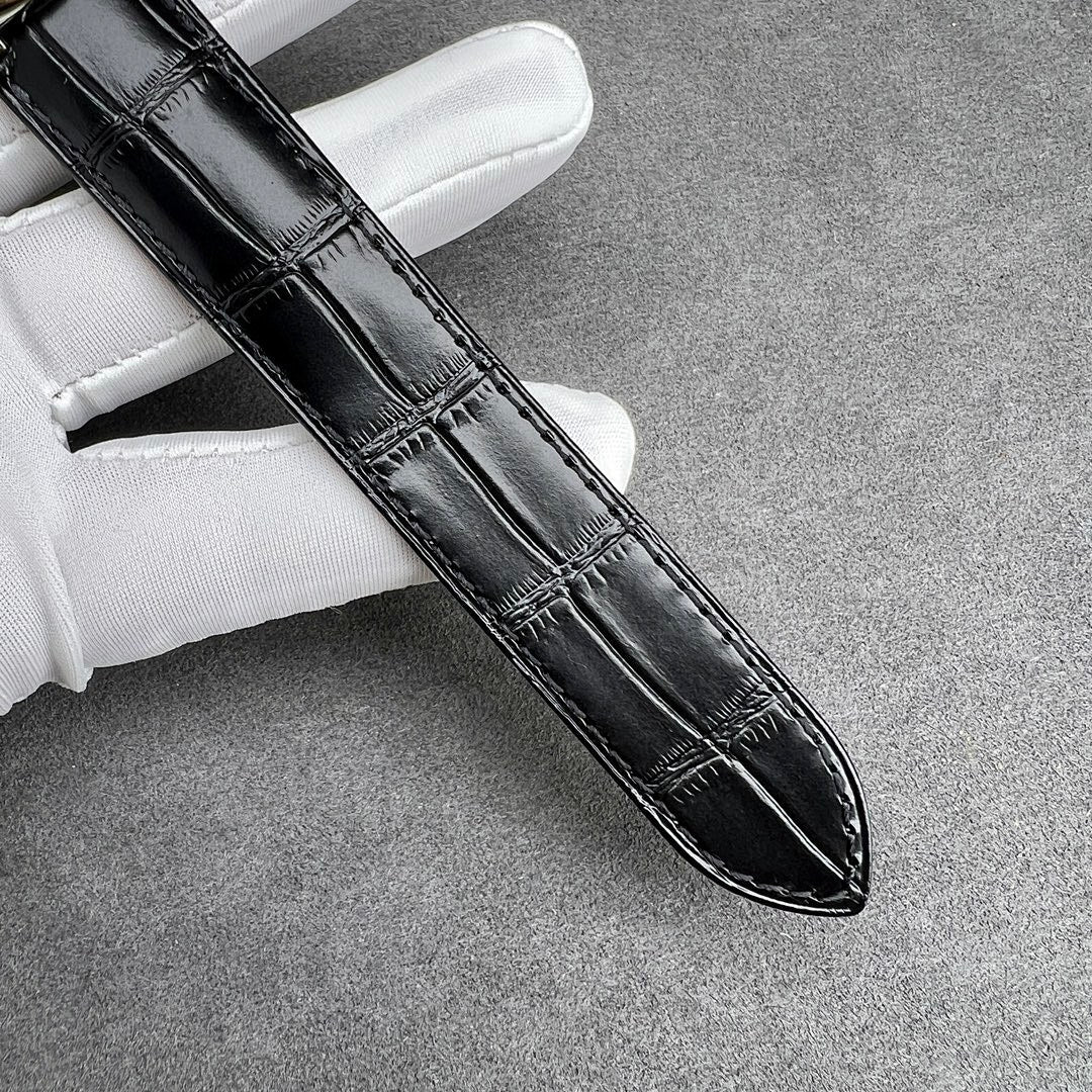 Cartier watch black leather strap with stitched pattern, silver case edge visible.