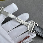 Cartier watch buckle and black leather strap, silver clasp with metal keeper.