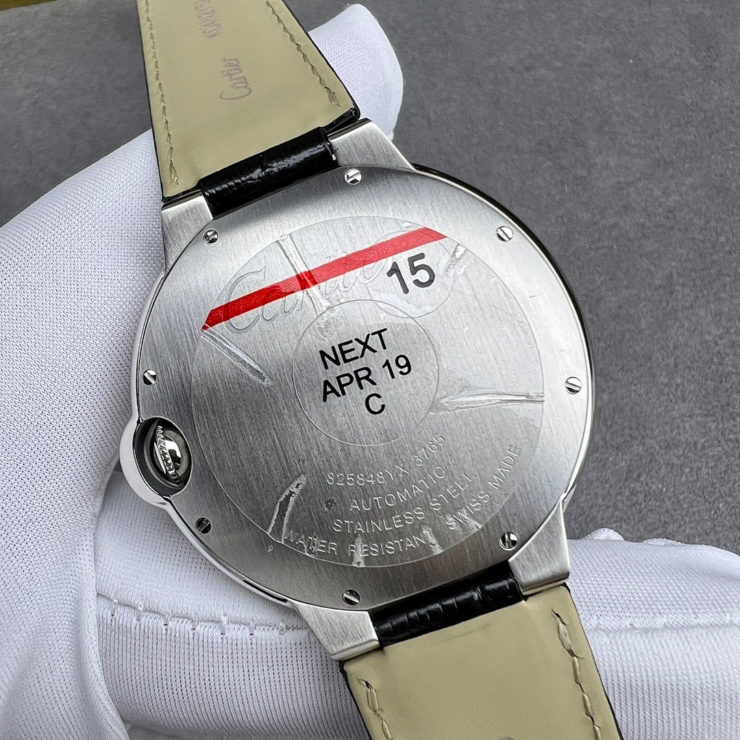 Cartier watch caseback in silver with date window, black leather strap attached.
