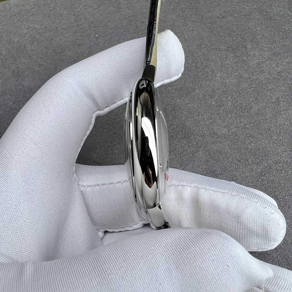 Cartier watch side profile with polished silver case and black leather strap.