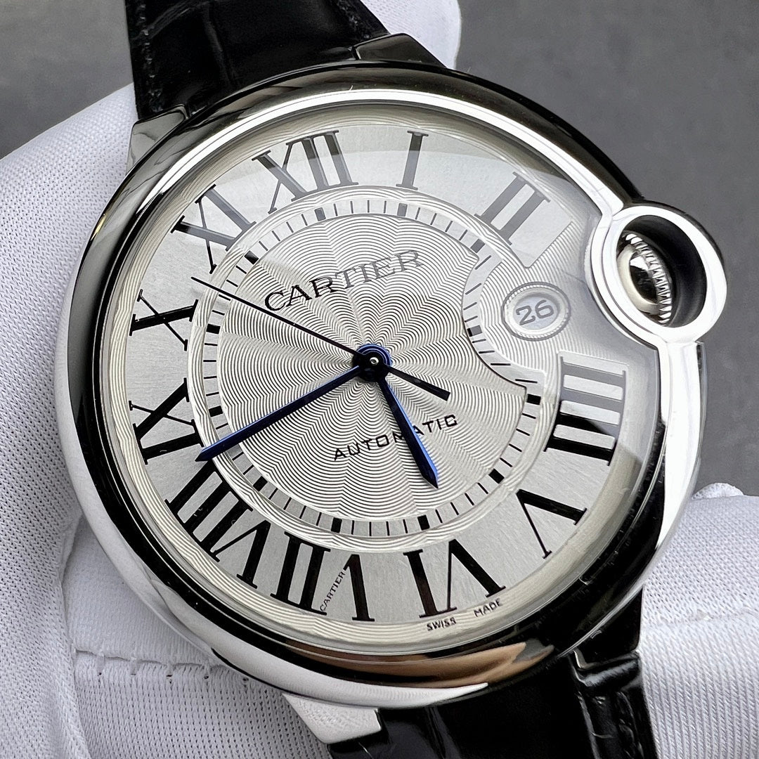 Cartier watch close-up: silver dial with Roman numerals, blue seconds hand, black leather.
