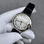 Cartier watch front view with black leather strap, Roman numeral white dial, crown detail.