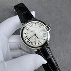 Cartier watch three-quarter view: black leather strap, silver case, Roman numeral white dial.
