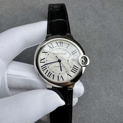 Cartier watch with black leather strap and silver case, white dial with Roman numerals.