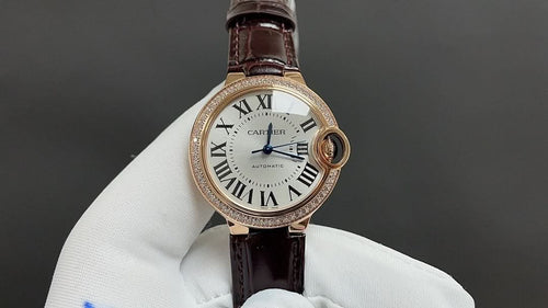 Cartier watch: white dial, Roman numerals, brown leather strap, rose gold case.