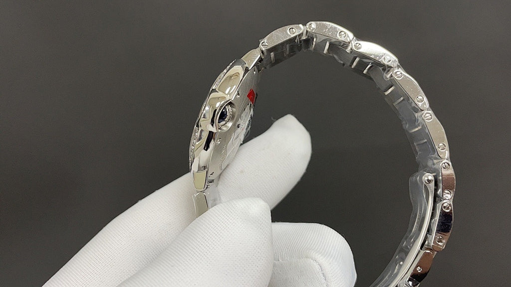 Cartier watch bracelet links and polished case edge in a silver finish.