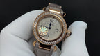 Gold-tone wristwatch with diamond bezel, cream leather strap, round dial and hands