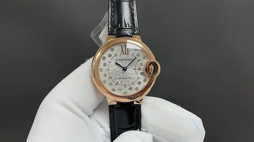 Cartier watch with silver dial, Roman numerals, rose-gold case, black leather strap