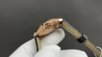Cartier watch case back angle with rose-gold tone and black leather strap detail