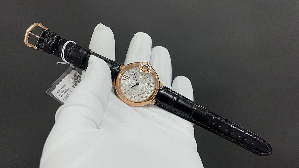Cartier watch on black leather strap, round rose-gold case with silver dial