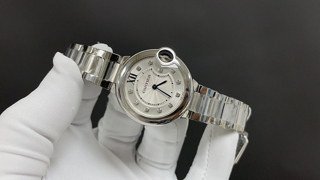 Cartier round watch with silver bracelet links and white dial, side and crown detail.