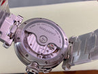 Cartier wristwatch open caseback showing mechanical movement and stainless steel back