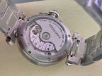 Cartier wristwatch caseback with visible automatic movement under glass