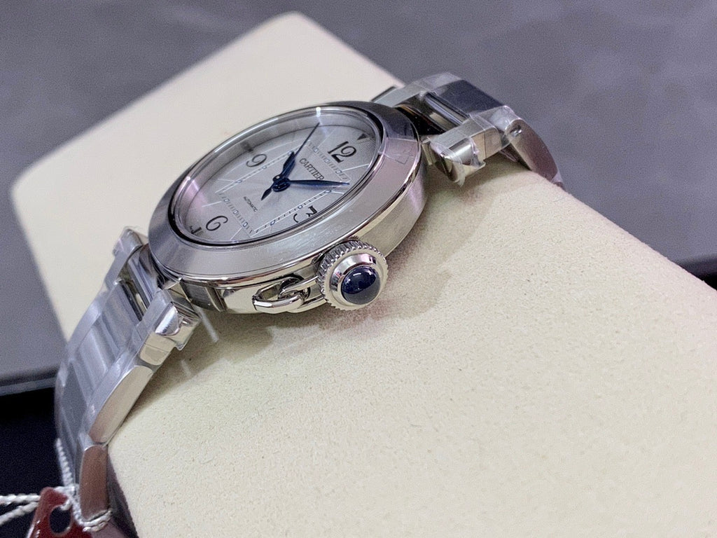 Cartier wristwatch side view with round case, crown detail, and stainless steel strap
