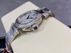 Cartier wristwatch side view with round case, crown detail, and stainless steel strap