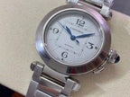 Cartier wristwatch top view with silver dial, blue hands, and stainless steel bracelet