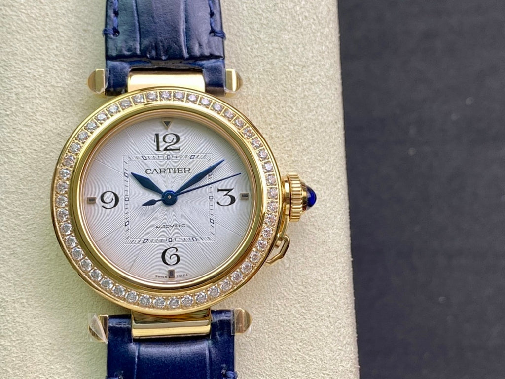 Cartier watch front view with gold case, diamond bezel, blue leather strap
