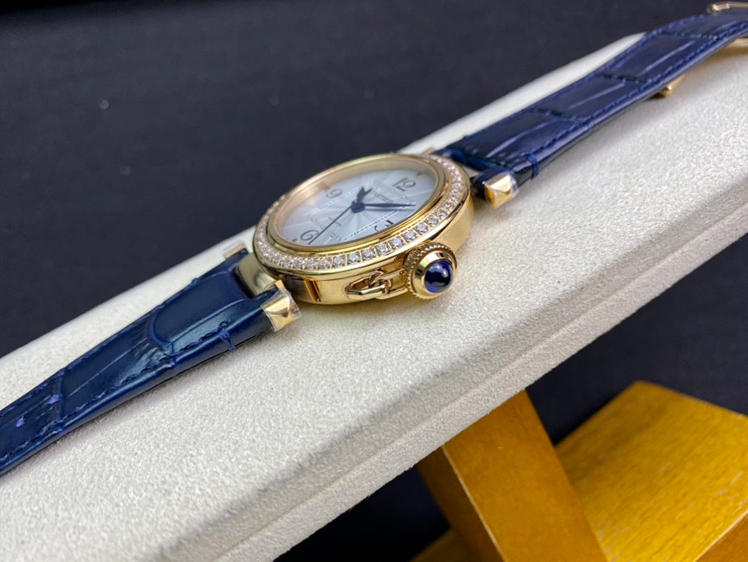 Cartier watch side view with blue leather strap and gold case accents