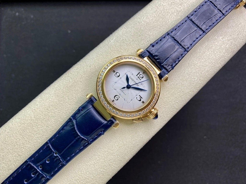 Cartier watch front view with blue leather strap and diamond bezel on display