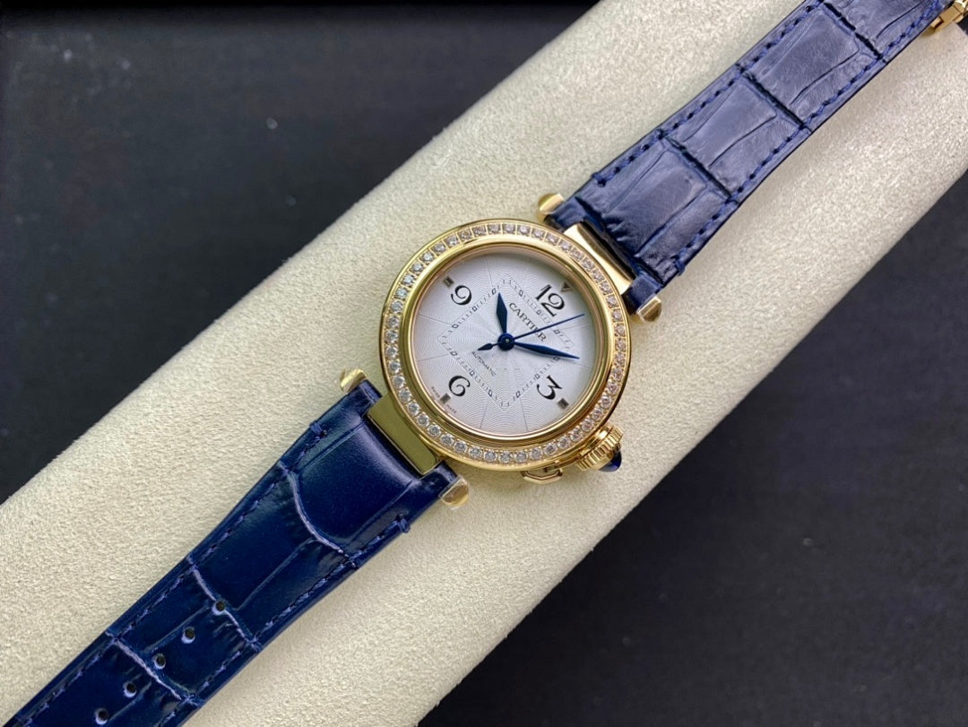 Cartier watch front view with blue leather strap and diamond bezel on display