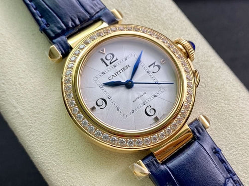 Cartier watch angled view with gold bezel and diamond trim, blue leather strap