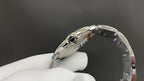 Cartier watch side view with bracelet links and crown, silver-tone metal