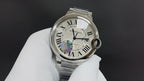 Cartier watch front close-up, Roman numeral dial with iridescent motif
