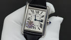 Wristwatch with black leather strap and white dial, Roman numerals