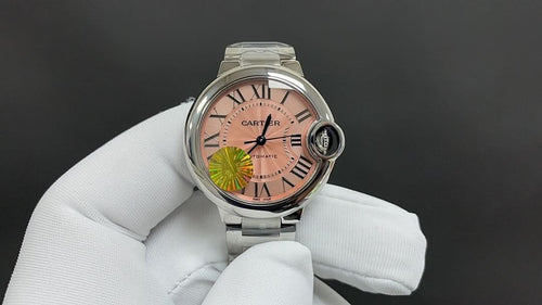 Cartier wristwatch with pink dial and Roman numerals, silver metal bracelet