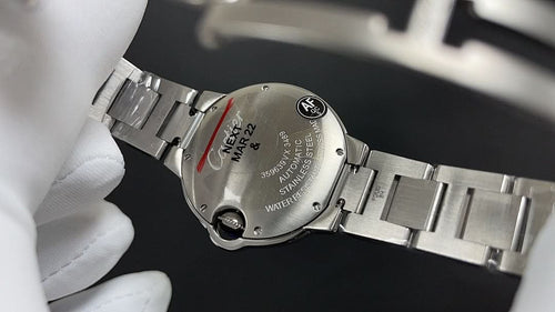 Cartier wristwatch close-up, engraved caseback and silver link bracelet