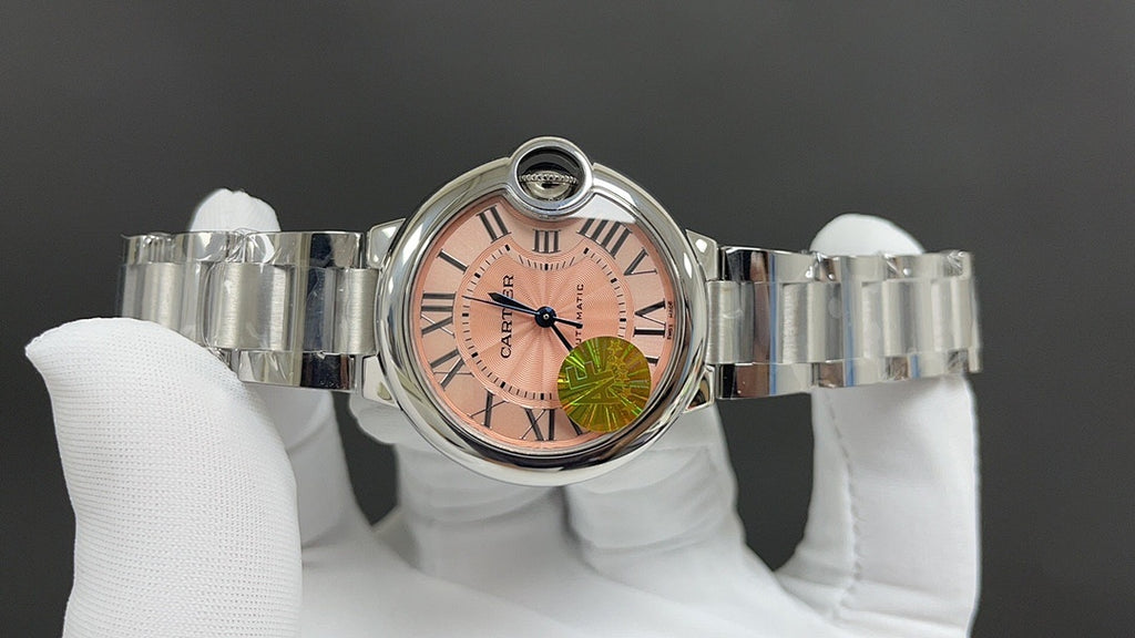 Cartier wristwatch front view with pink dial and Roman numerals, metal bracelet
