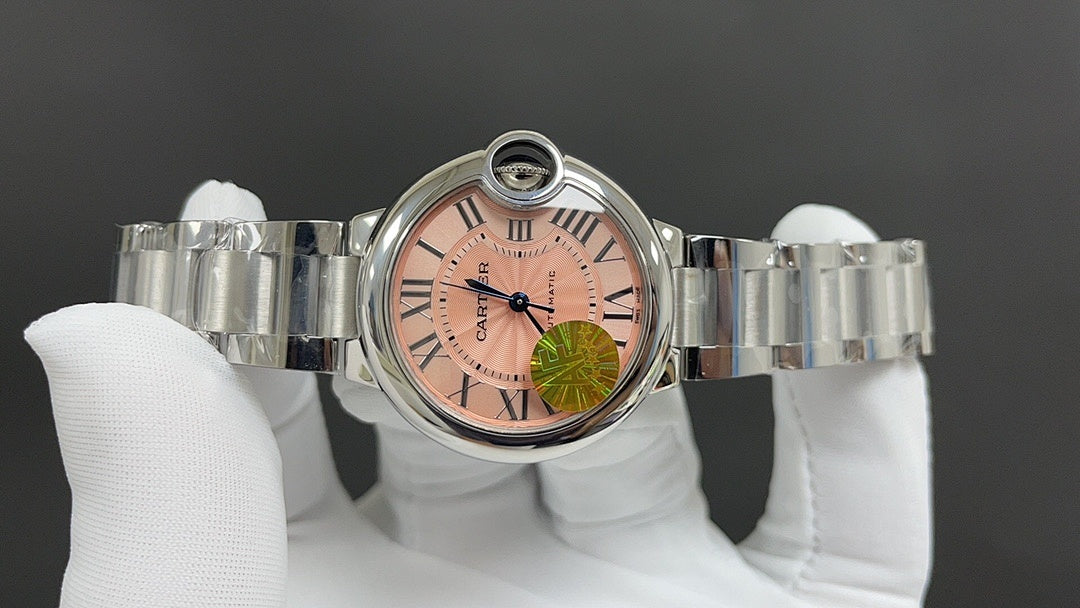Cartier wristwatch front view with pink dial and Roman numerals, metal bracelet
