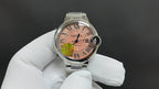 Cartier wristwatch on glove, pink dial with Roman numerals and steel bracelet