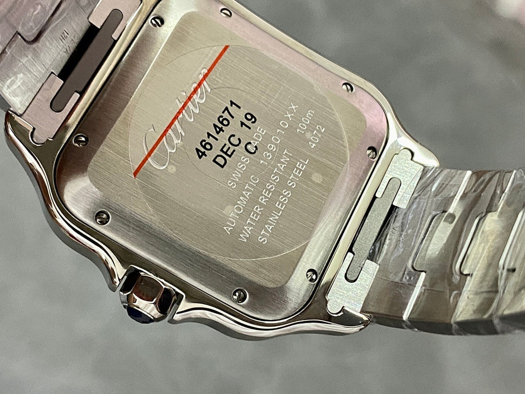 Cartier watch case back with engraved text and stainless steel bracelet