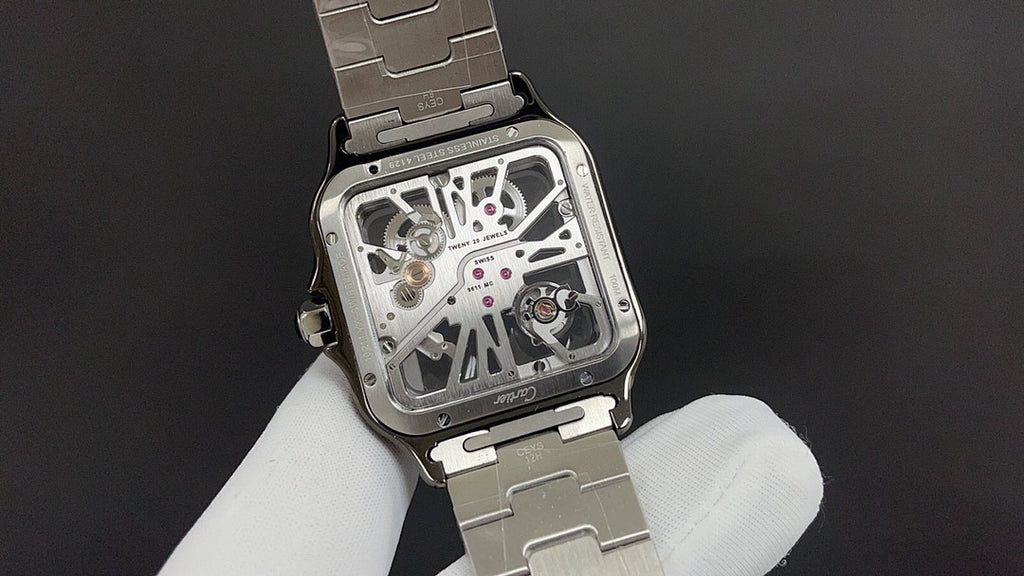 Luxury watch by Cartier with exposed movement and silver-toned metal case