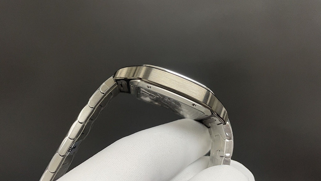 Luxury watch by Cartier with silver-toned case back and metal link bracelet