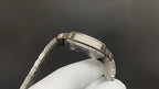 Luxury watch by Cartier with silver-toned case back and metal link bracelet