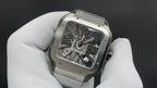 Luxury watch by Cartier with skeleton face and silver-toned metal case