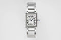Cartier watch with rectangular silver dial, Roman numerals, and stainless steel bracelet