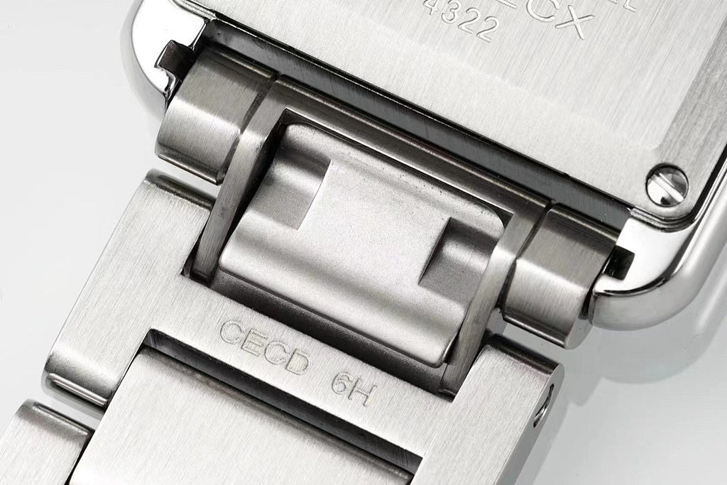 Cartier watch case close-up with brushed silver metal and black bezel accents