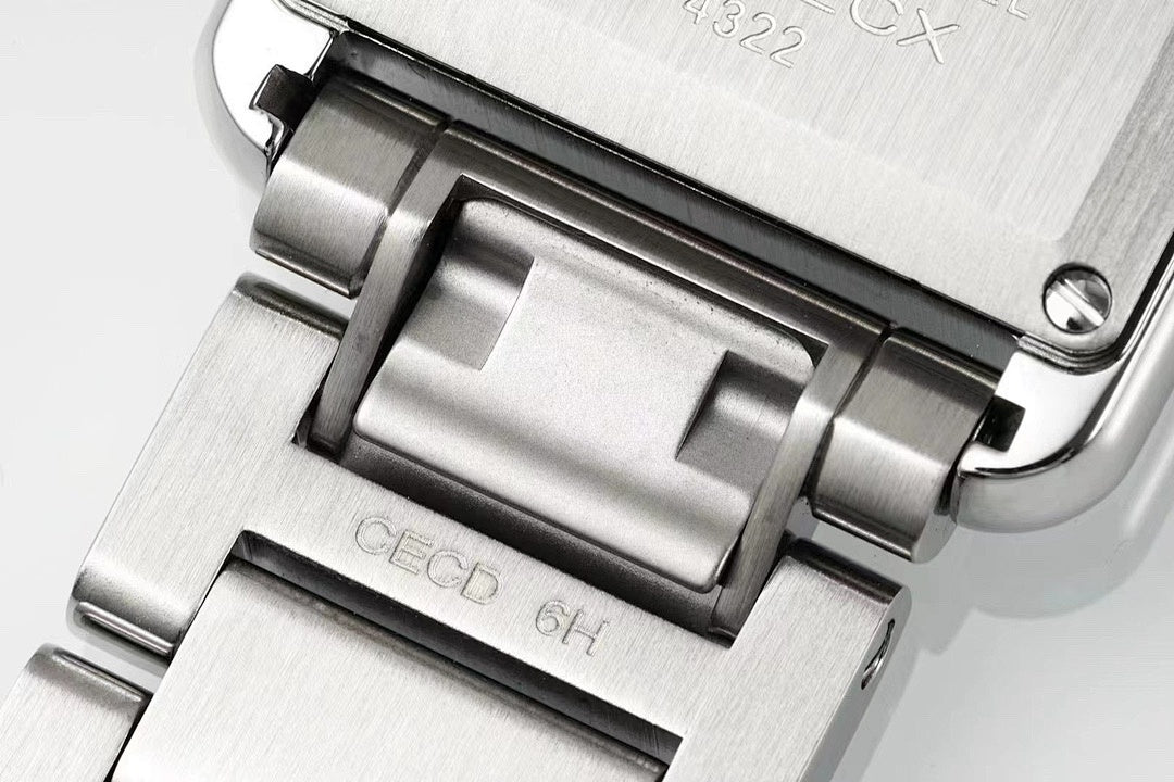 Cartier watch case close-up with brushed silver metal and black bezel accents