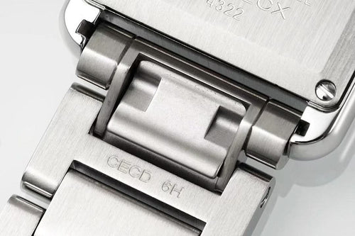 Cartier watch case close-up with brushed silver metal and black bezel accents